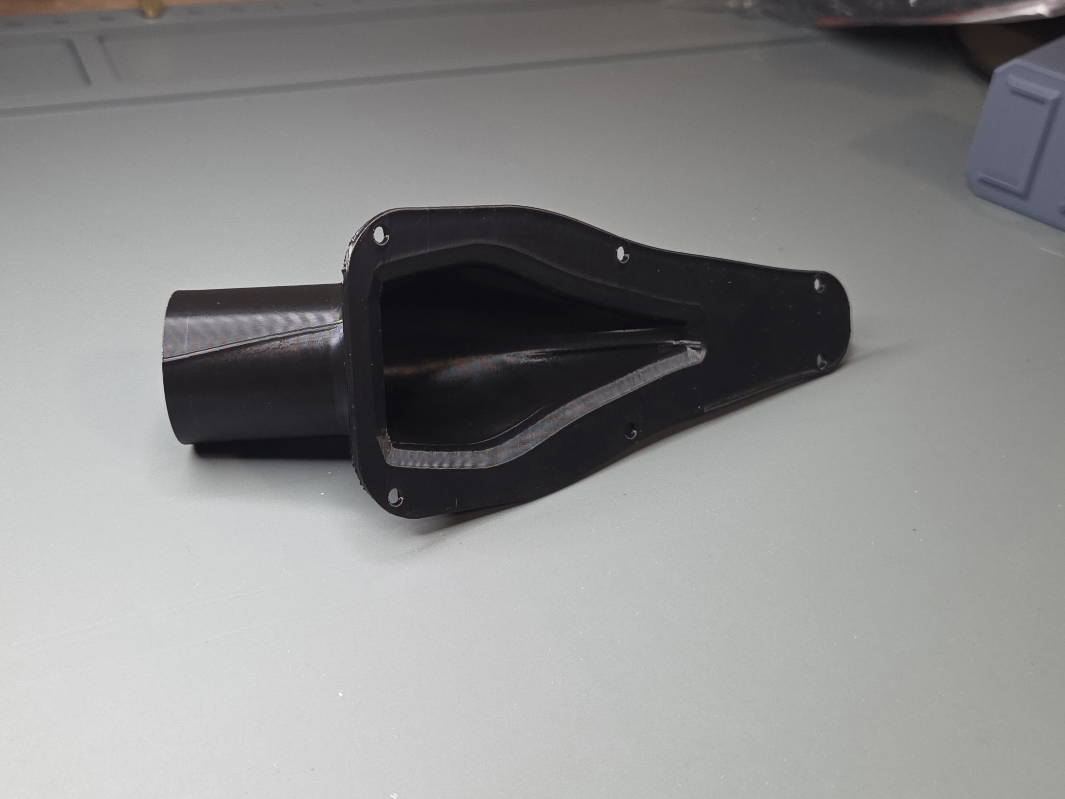 Custom air duct showing asymmetric internal flow geometry, single-piece cavity from inlet to outlet