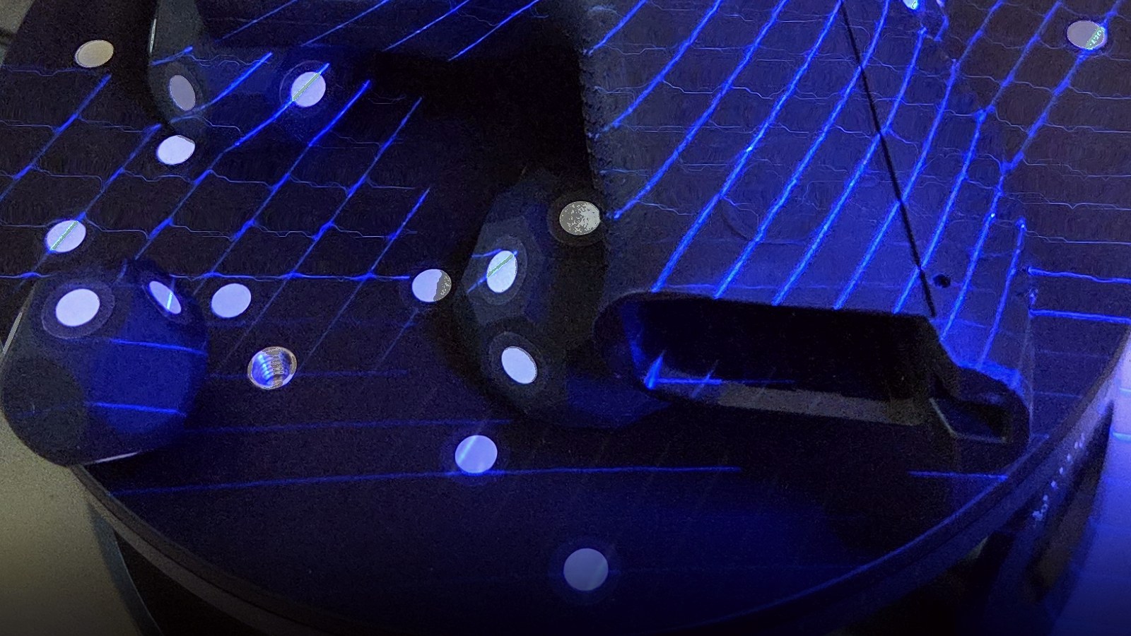 Blue laser lines from a Revopoint MetroX Pro scanner sweeping across a marker-covered scanning turntable