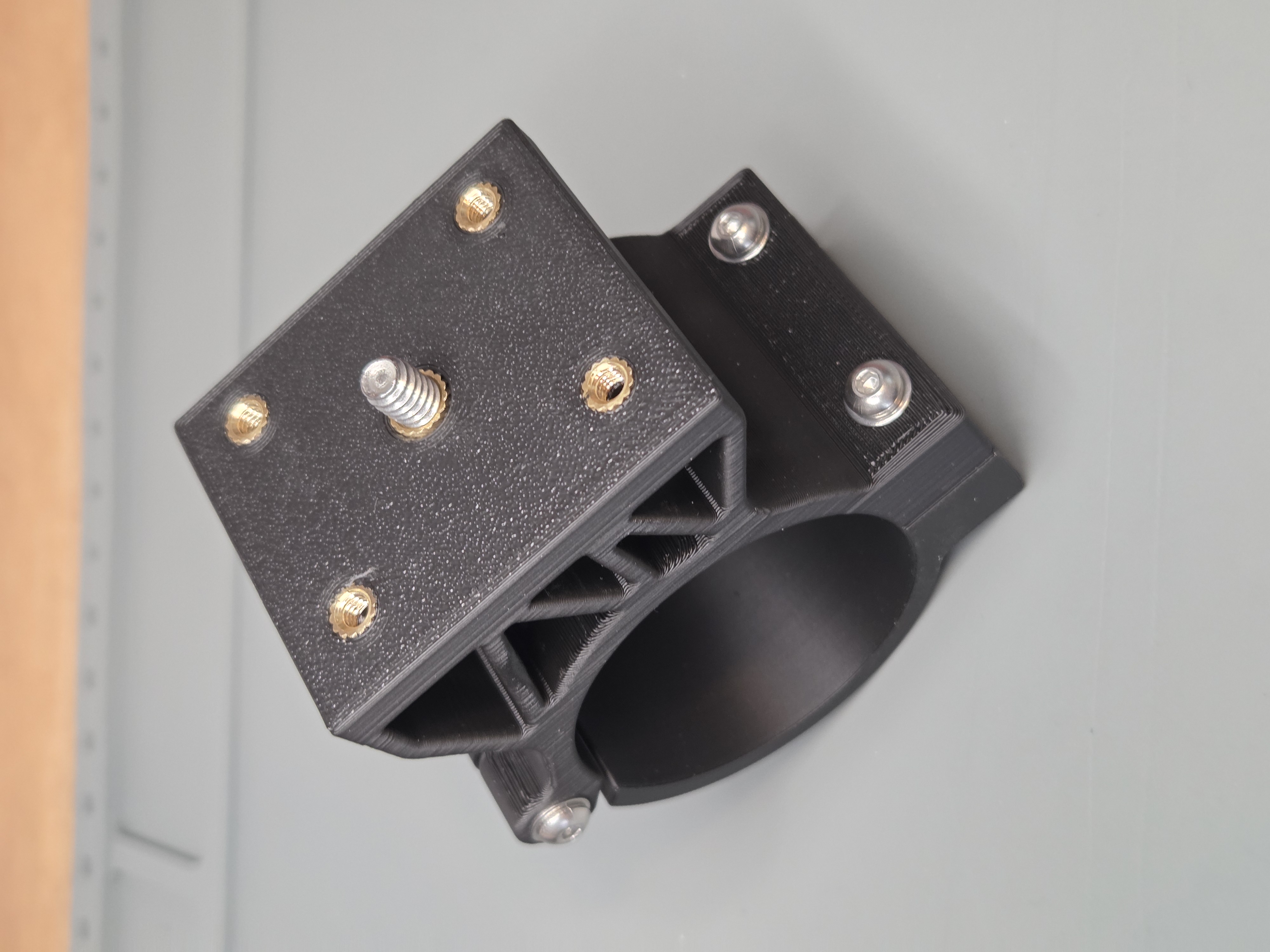 Universal 2-inch clamp mount top detail showing brass heat-set inserts and 1/4-20 mounting stud